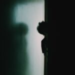 person in black shirt standing on gray concrete floor