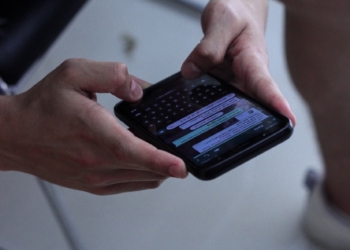 person holding black iphone 4