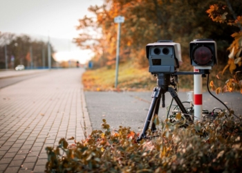 black and gray camera on tripod on road during daytime