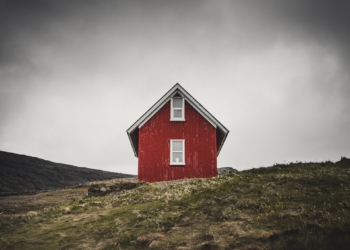 photo of red barn house on top of hill