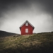 photo of red barn house on top of hill
