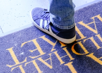 a close up of a person standing on a skateboard