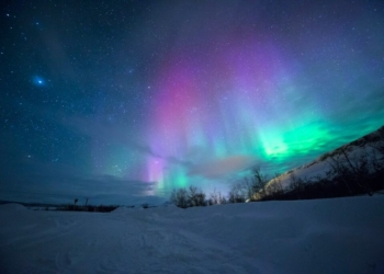 northern lights over snow-capped mountian