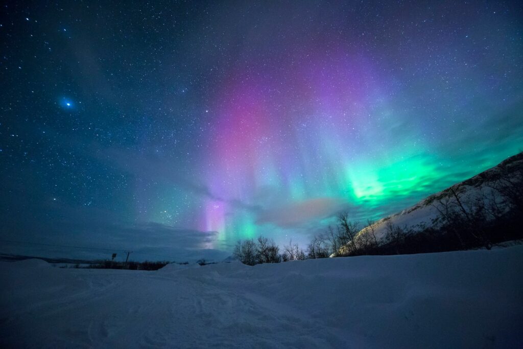 northern lights over snow-capped mountian