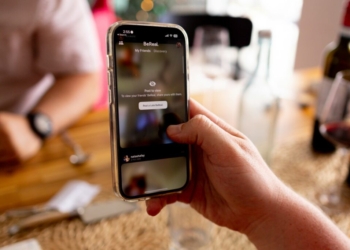 a person holding a cell phone in their hand