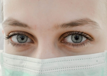 closeup photo of woman's eye wearing mask