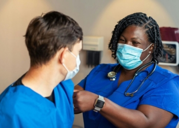 a woman in a blue scrub suit and a man in a blue scrub suit