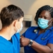 a woman in a blue scrub suit and a man in a blue scrub suit