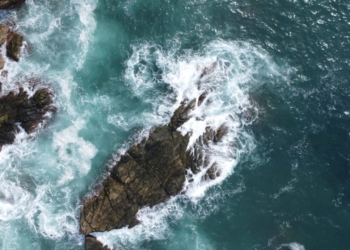 An aerial view of the ocean and rocks