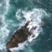 An aerial view of the ocean and rocks