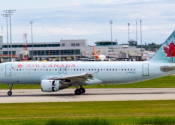 white and red passenger plane on airport during daytime