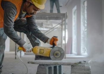 a man using a grinder on a piece of concrete