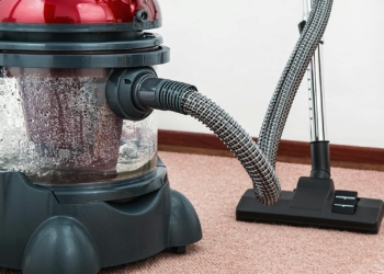 Black and Red Canister Vacuum Cleaner on Floor