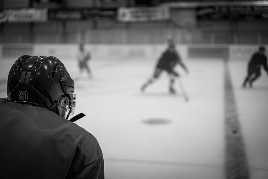 a group of people playing a game of ice hockey