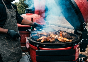 a person grilling meat on a grill