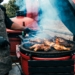 a person grilling meat on a grill