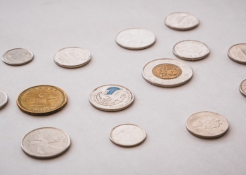 a bunch of different types of coins on a table