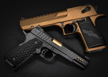 a gold and black gun on a black background