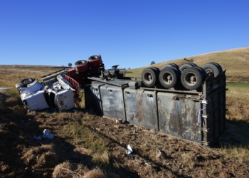 red and white truck on brown field during daytime