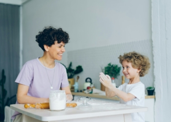 a woman and a child are sitting at a table