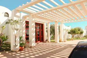 a car parked in front of a white house