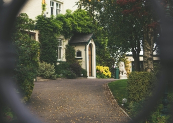 minimalist photography of house shot in front of chain fence