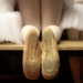 a pair of ballet shoes sitting on top of a wooden shelf