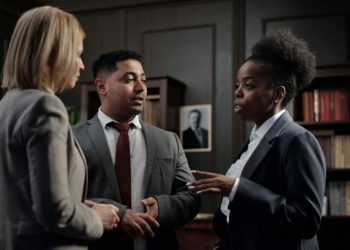 Diverse professionals engaged in strategic discussion in a law office setting.