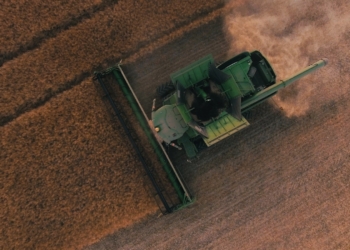 green farming equipment on brown field