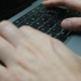 a person typing on a laptop keyboard
