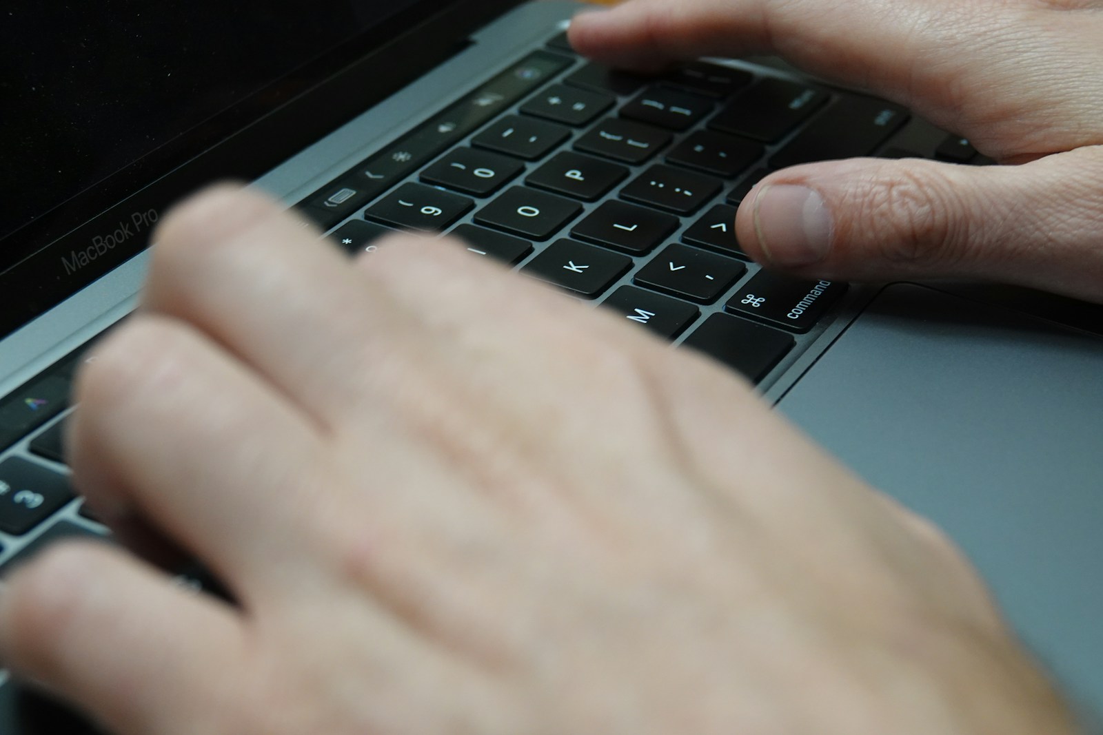 a person typing on a laptop keyboard