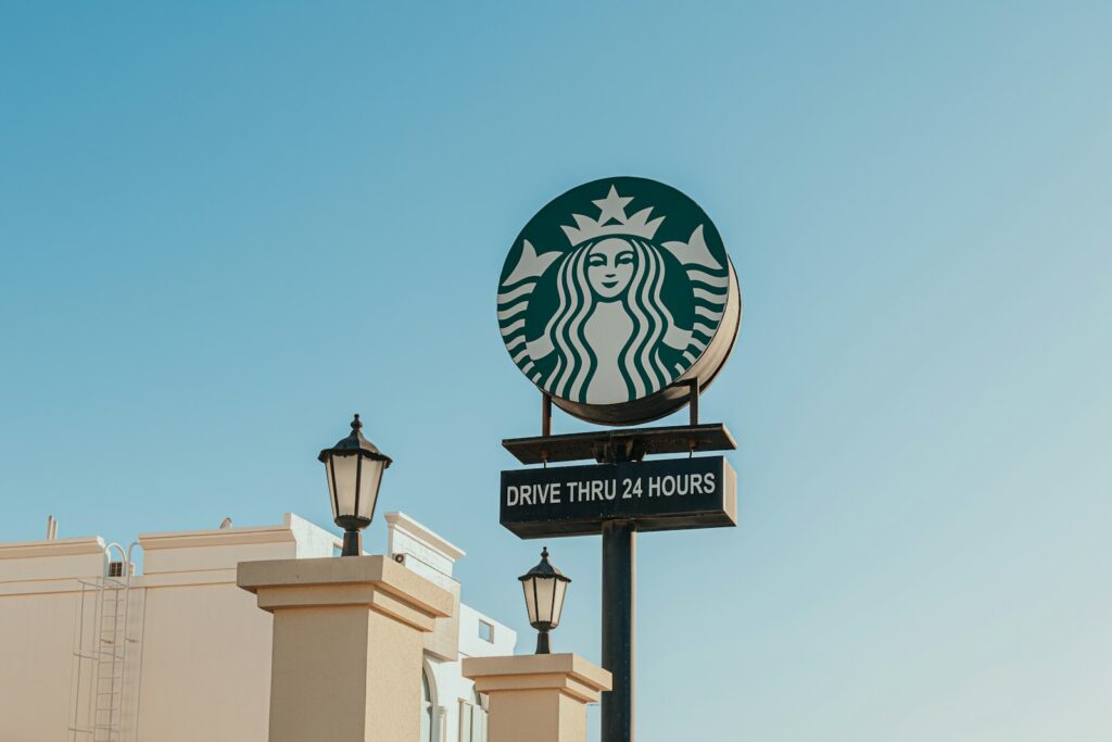 A starbucks sign on top of a building