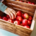 red fruits in brown wooden crate