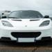 A white sports car parked in a parking lot