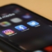black iphone 4 on brown wooden table