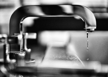 grayscale photography of faucet