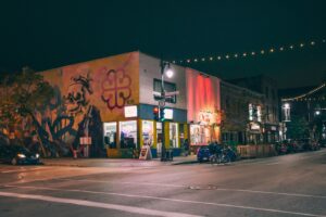 blue vehicle parked beside road during nighttime