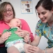 a woman holding a baby in a hospital room