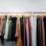 assorted-color clothes lot hanging on wooden wall rack