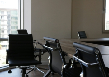 five black rolling chars front of desk