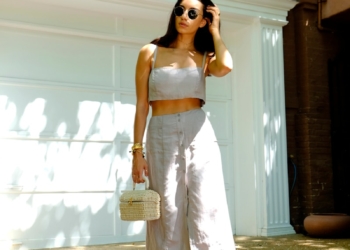woman in white spaghetti strap dress wearing sunglasses standing near white wall during daytime