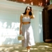 woman in white spaghetti strap dress wearing sunglasses standing near white wall during daytime