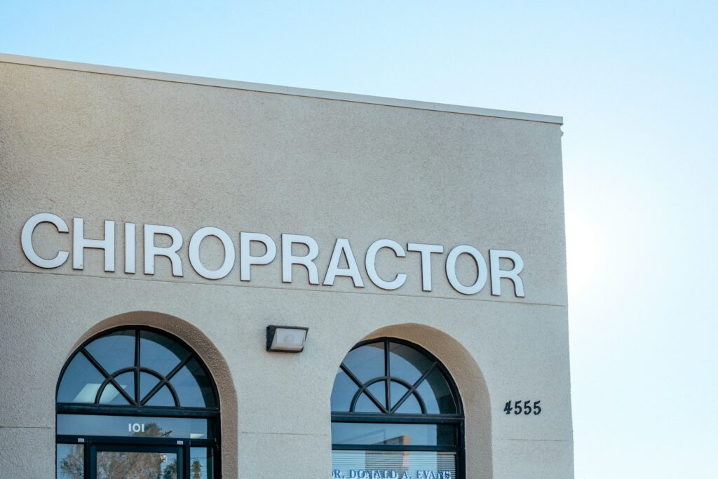 a building with two arched windows and a sign that says chiropractor