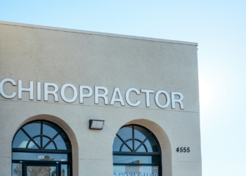 a building with two arched windows and a sign that says chiropractor