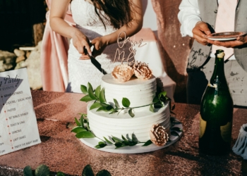woman in white dress holding white and blue floral ceramic bowl with food