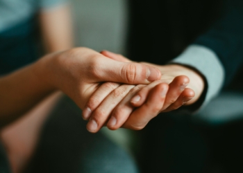person holding babys hand