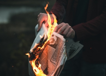 person holding burned paper