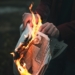 person holding burned paper