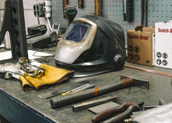 a welding helmet sitting on top of a workbench