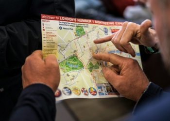 two people pointing at London's number one sightseeing map